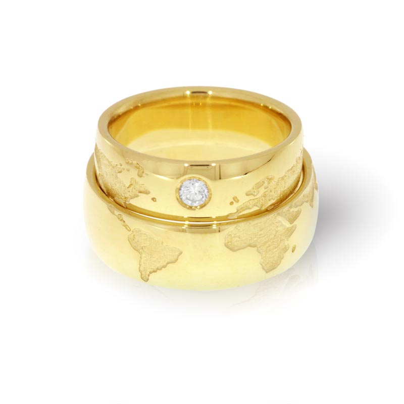 Wedding rings in gold with a map of the world